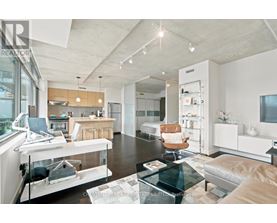 A modern kitchen with a glass table and white cabinets.