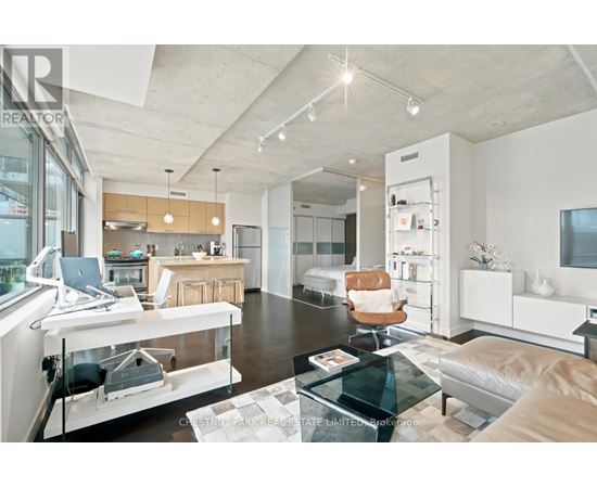 A modern kitchen with a glass table and white cabinets.