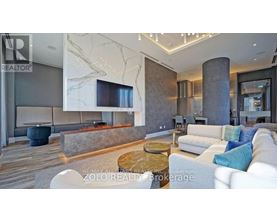A modern living room with a fireplace and a large couch.