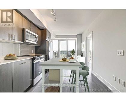 A modern kitchen with a dining table and chairs.