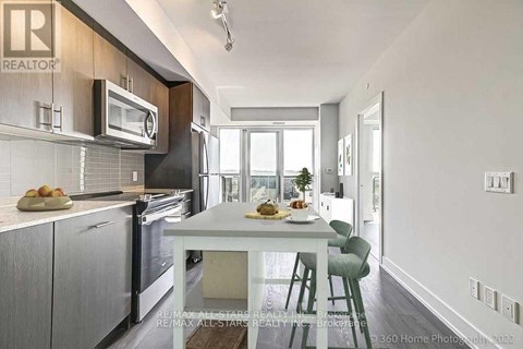 A modern kitchen with a dining table and chairs.