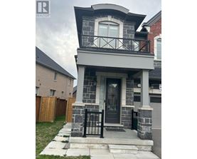 A house with a grey front porch and black railings.
