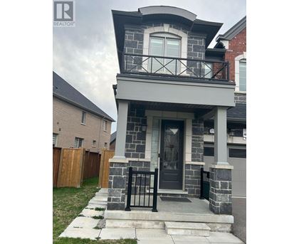 A house with a grey front porch and black railings.