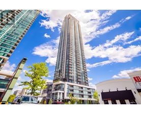 A tall building stands in the middle of a city street.