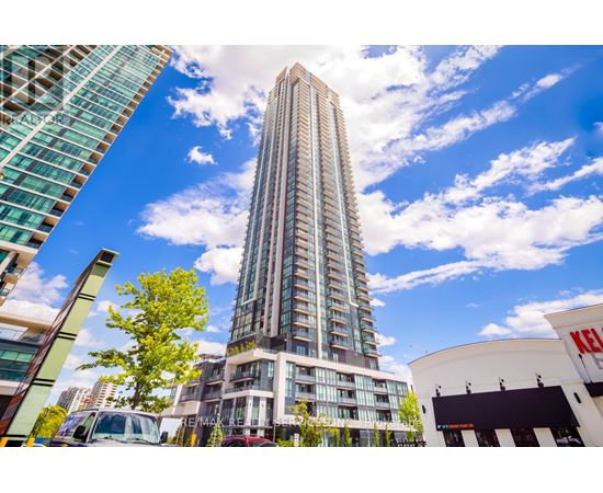 A tall building stands in the middle of a city street.
