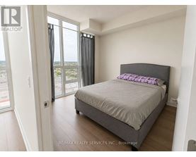 A bedroom with a large bed and a view of the city.