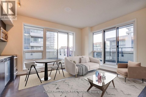 A modern living room with a glass table and a sofa.