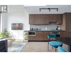 A modern kitchen with a dining table and chairs.