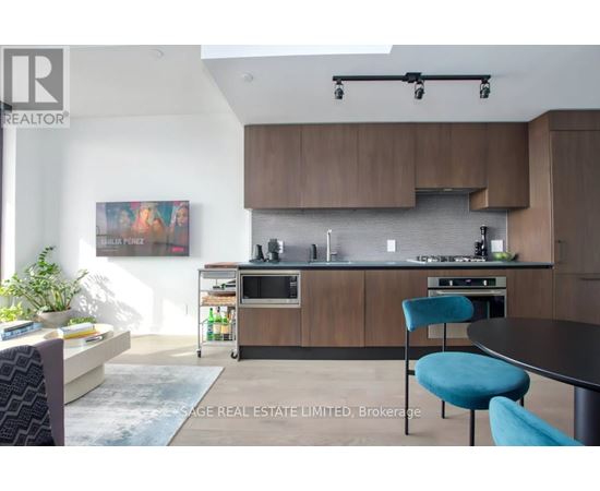 A modern kitchen with a dining table and chairs.