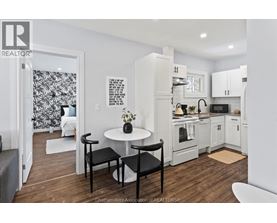 A kitchen with a table and chairs in the middle of the room.