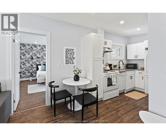 A kitchen with a table and chairs in the middle of the room.