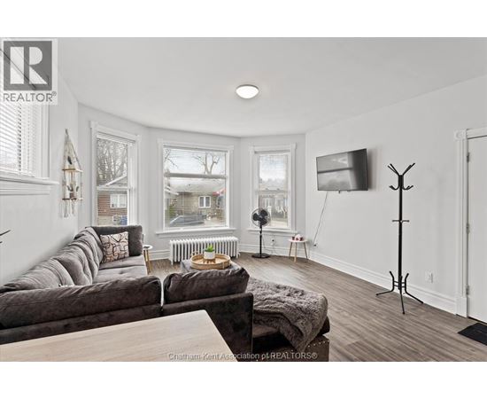 A living room with a grey couch and a wooden coffee table.