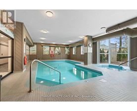 A large indoor swimming pool with a slide in a spacious room.