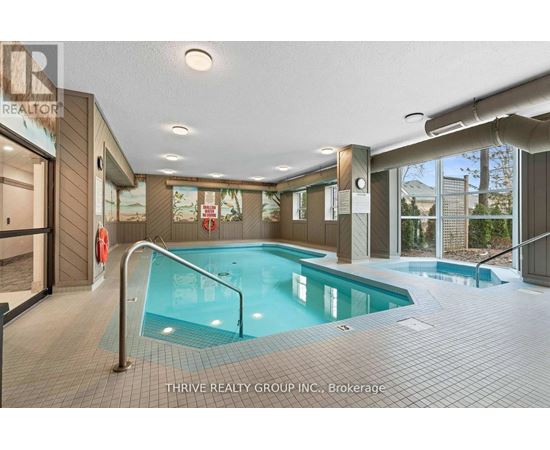 A large indoor swimming pool with a slide in a spacious room.