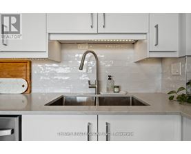A kitchen with a sink and a logo that says REALTOR.