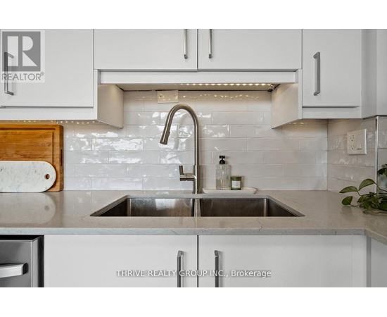 A kitchen with a sink and a logo that says REALTOR.