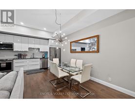 A modern kitchen with a dining table set up.