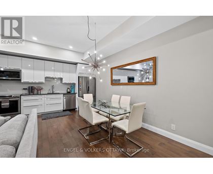 A modern kitchen with a dining table set up.