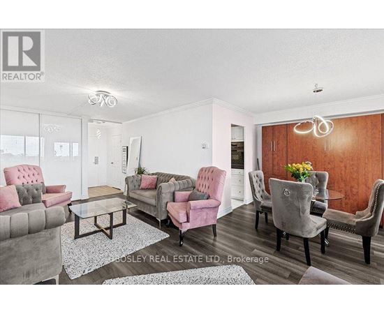 A living room with a grey and pink sofa set.
