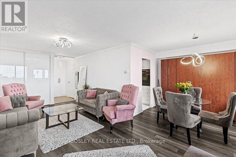 A living room with a grey and pink sofa set.