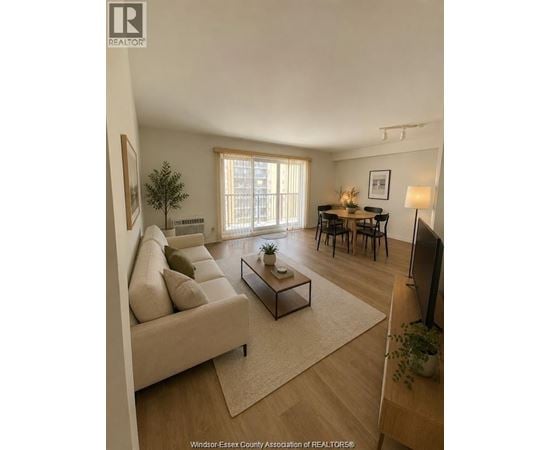 A living room with a couch, a coffee table, and a television.