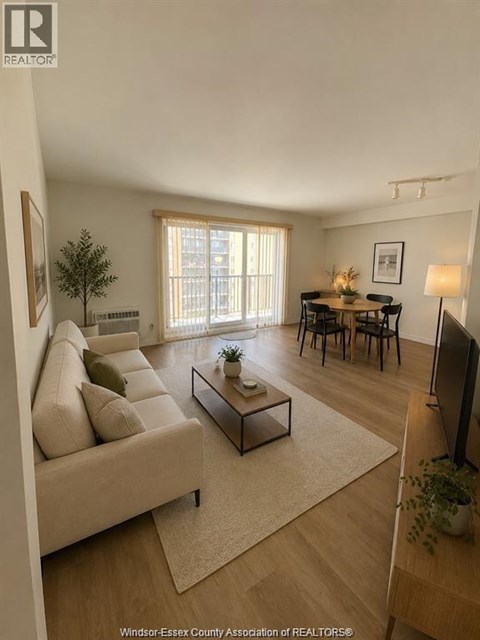 A living room with a couch, a coffee table, and a television.