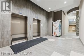 A hallway with a Realtor sign on the wall.
