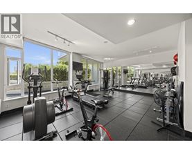 A gym with a variety of equipment including treadmills, weights, and exercise bikes.