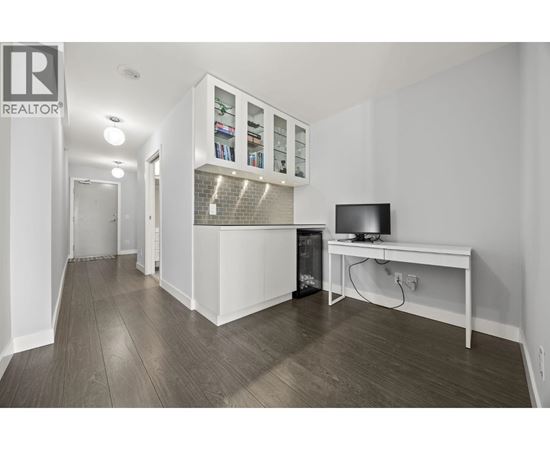 A living room with a television and a cabinet with glass doors.
