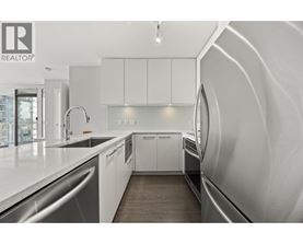 A modern kitchen with white cabinets and a sleek design.