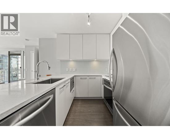 A modern kitchen with white cabinets and a sleek design.