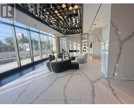 A spacious room with marble flooring and a ceiling lighting fixture.