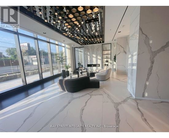 A spacious room with marble flooring and a ceiling lighting fixture.