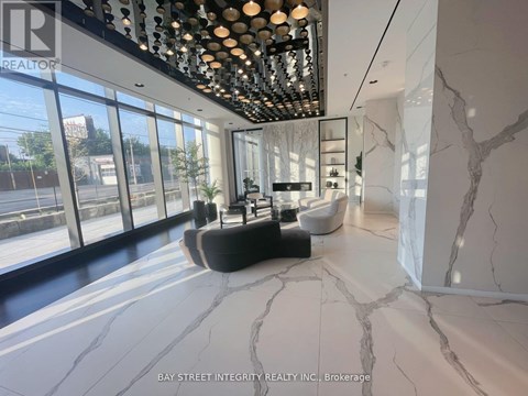 A spacious room with marble flooring and a ceiling lighting fixture.
