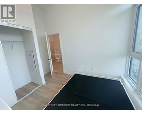 A room with a black mat on the floor and a door in the background.
