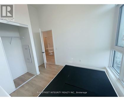 A room with a black mat on the floor and a door in the background.