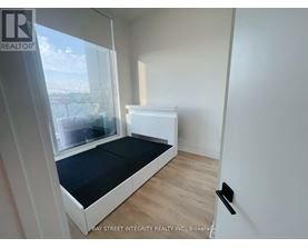 A bedroom with a bed and a window.