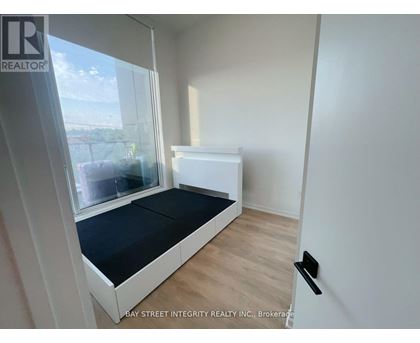 A bedroom with a bed and a window.
