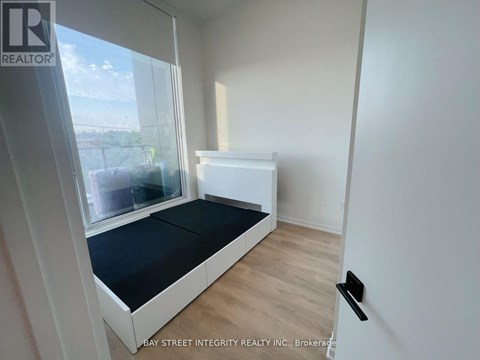 A bedroom with a bed and a window.