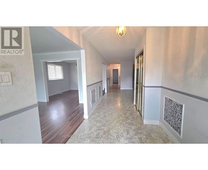 A hallway with a light switch on the wall.