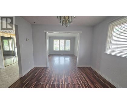 A room with wooden floors and a chandelier.