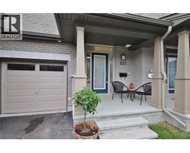 A house with a sign that says "REALTOR" on the left side of the entrance.