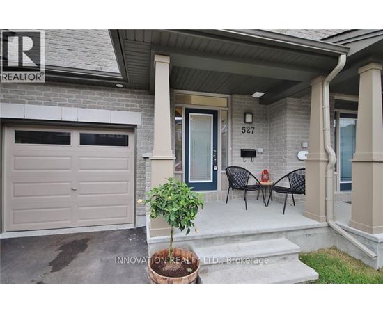 A house with a sign that says "REALTOR" on the left side of the entrance.