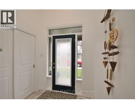 A door with a glass window is in the middle of a hallway.