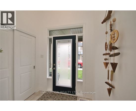 A door with a glass window is in the middle of a hallway.