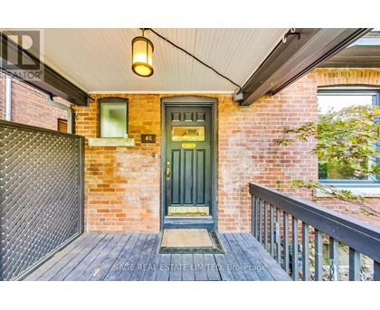 A green door is the centerpiece of this front porch.