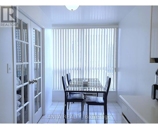 A dining room with a table and chairs.