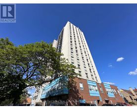 A tall building with a blue sky in the background.