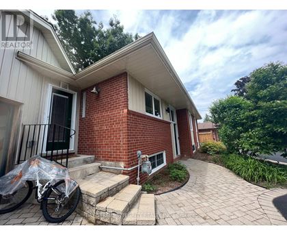 A brick house with a bicycle in front.