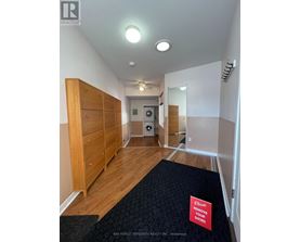 A hallway with a sign that says "Please remove your shoes".